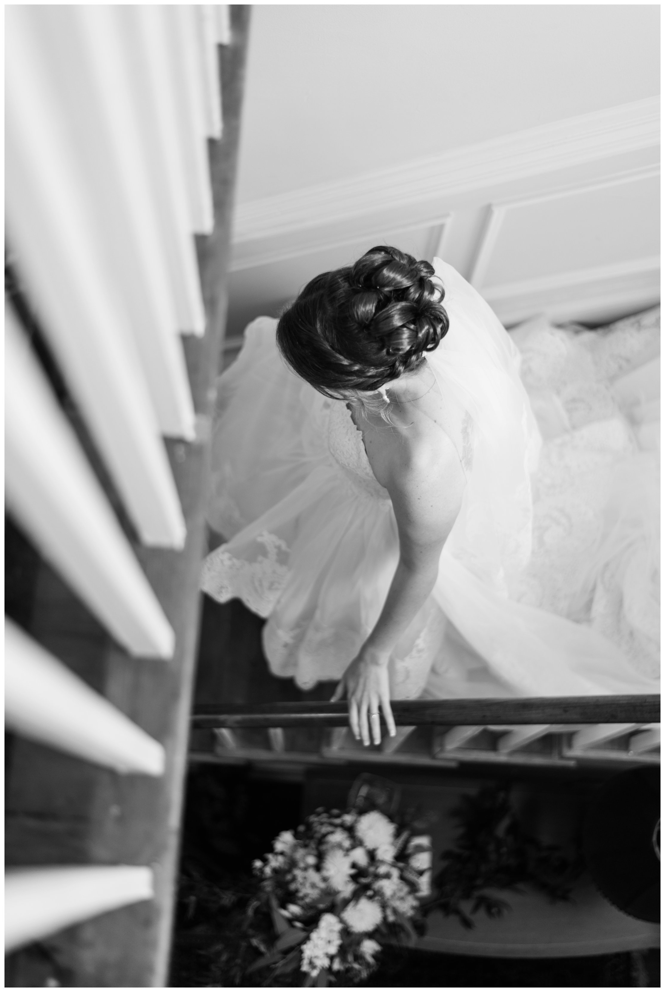 bride walks down stairs at estate at white hall vineyard wedding