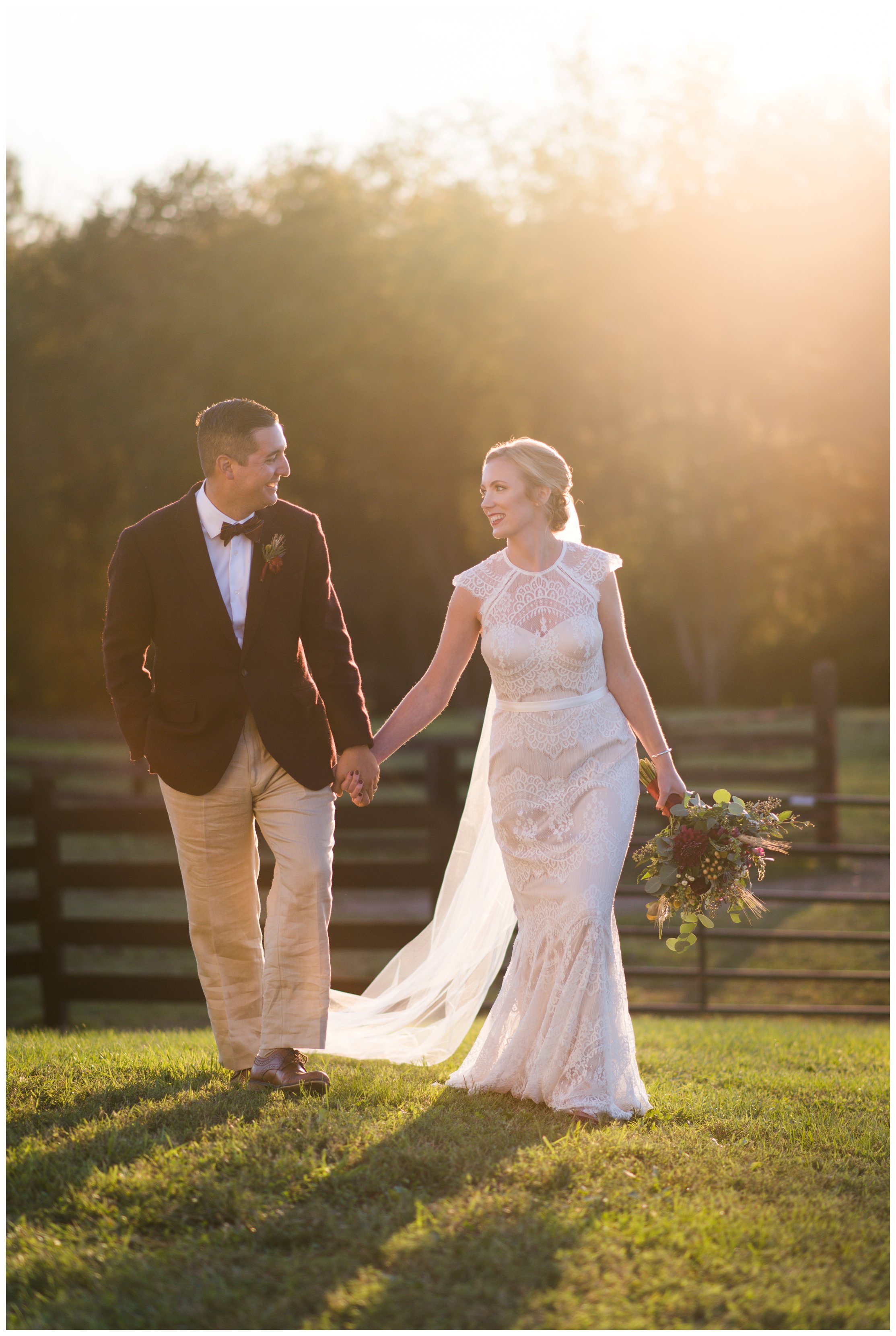 bride and groom walk at sunset at hermitage hill farm wedding