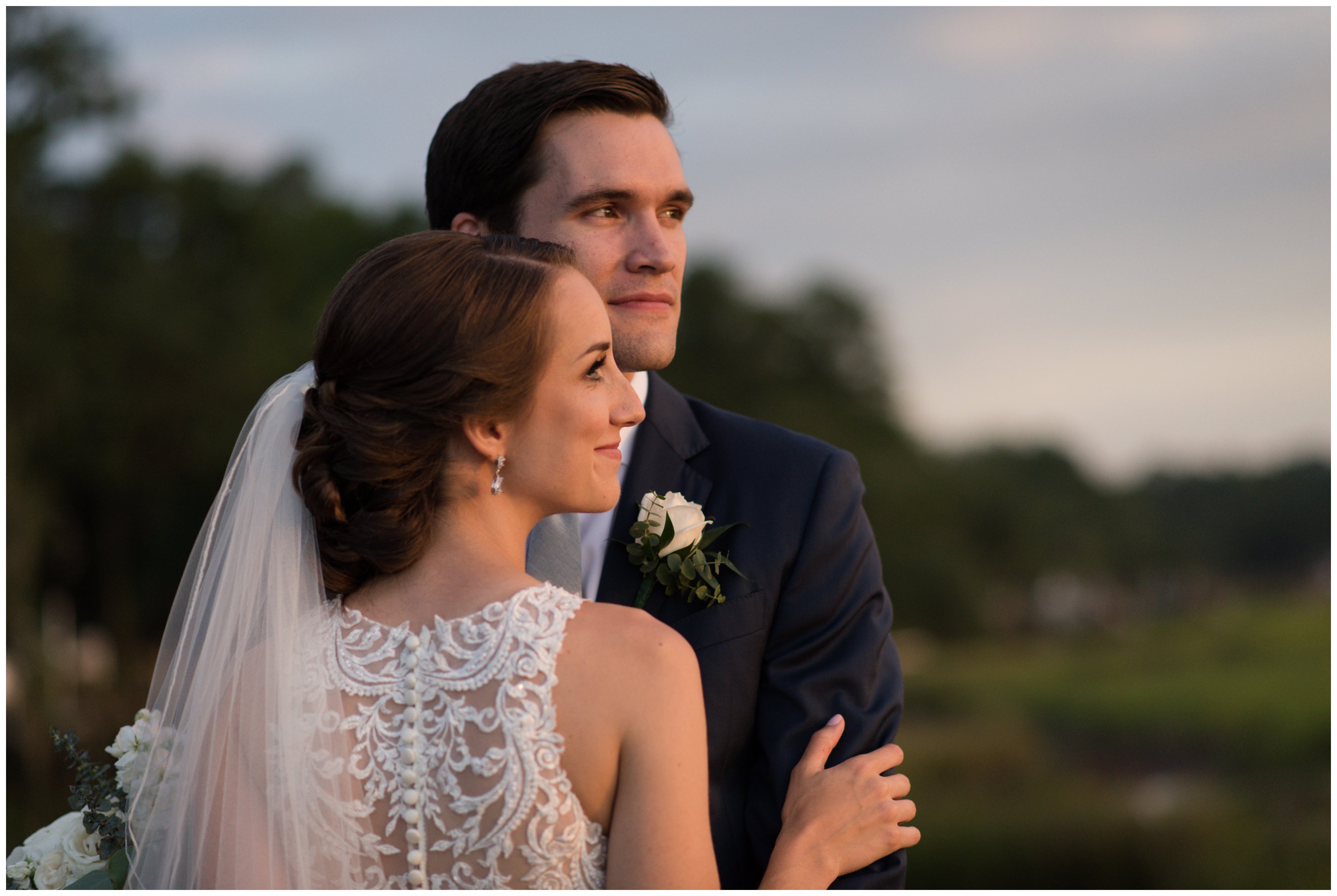 bride and groom watch sunset at south carolina wedding by sc wedding photographer