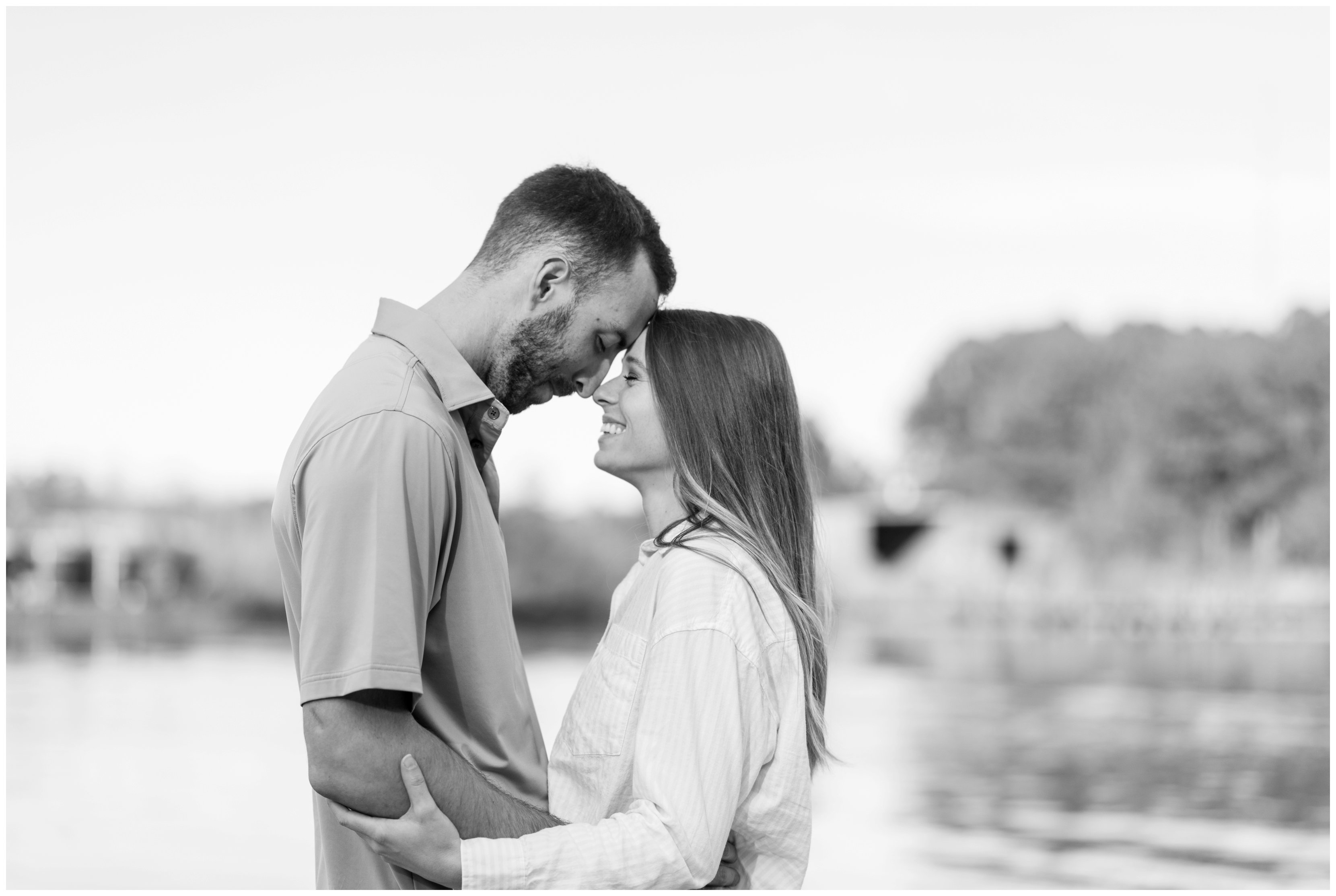couple smiling during engagement session by hampton roads wedding photographer