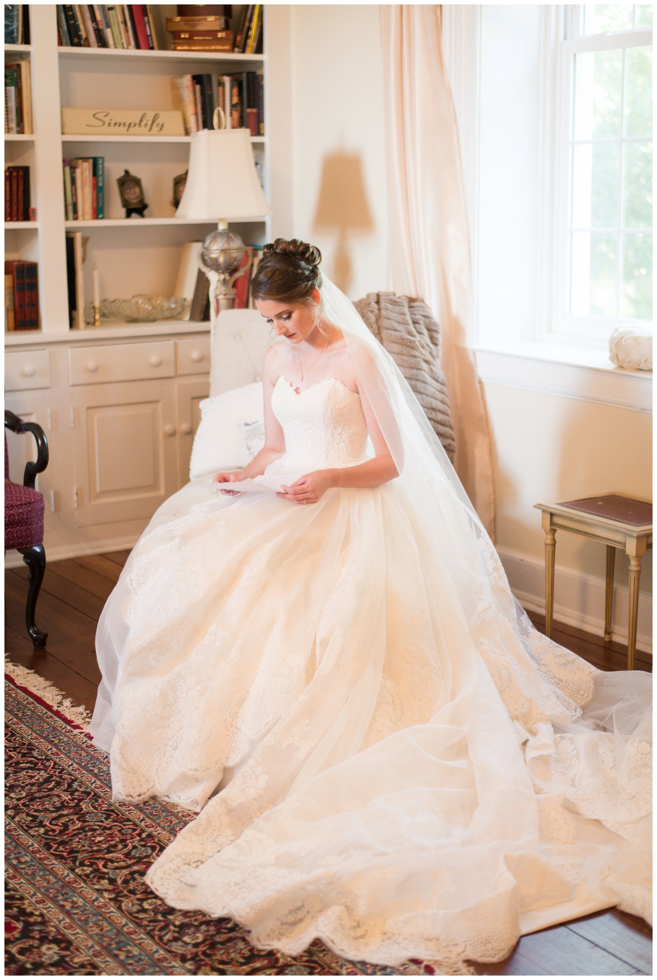 bride reads letter on wedding day at estate at white hall wedding