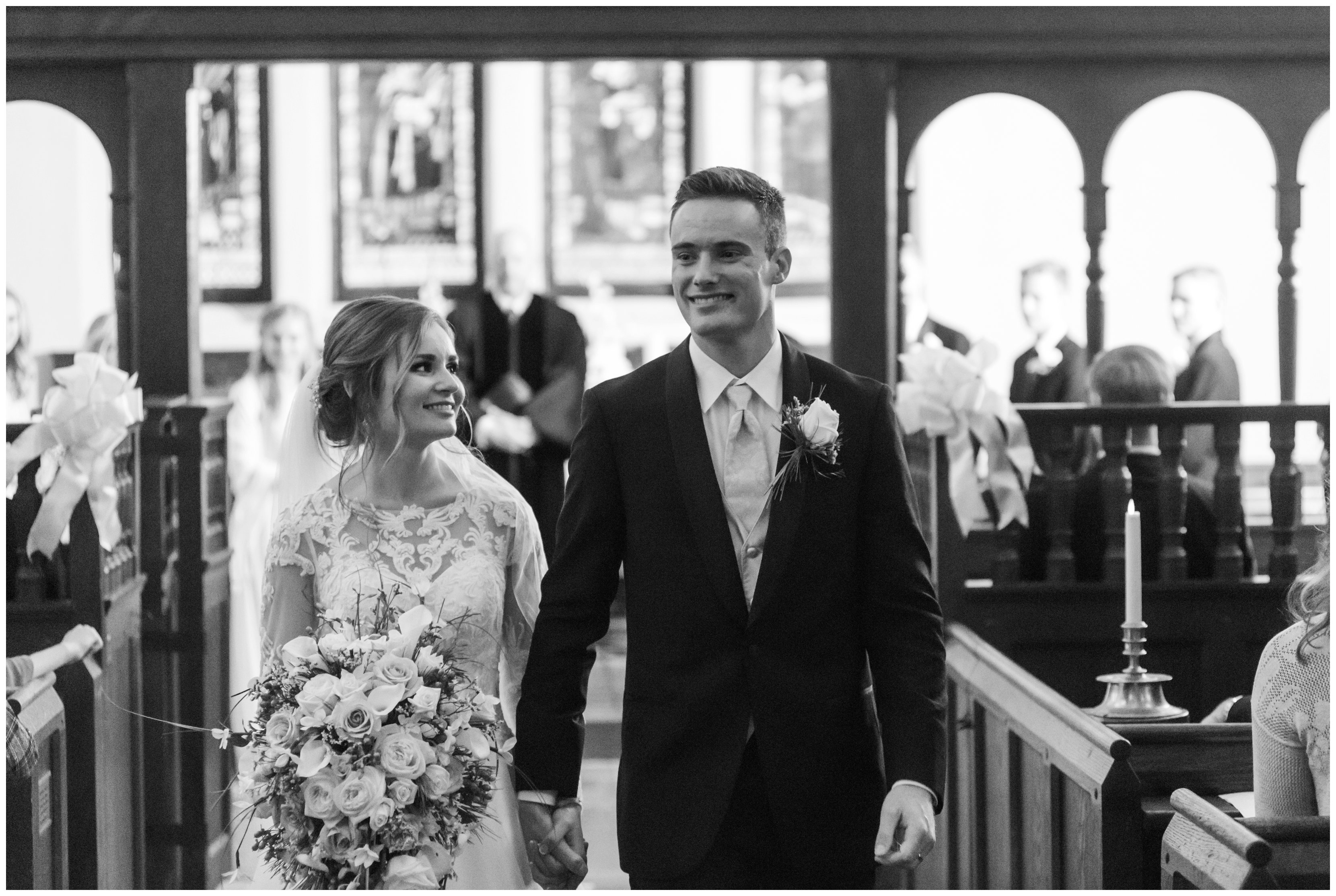 bride and groom walk down aisle after historic st lukes church wedding