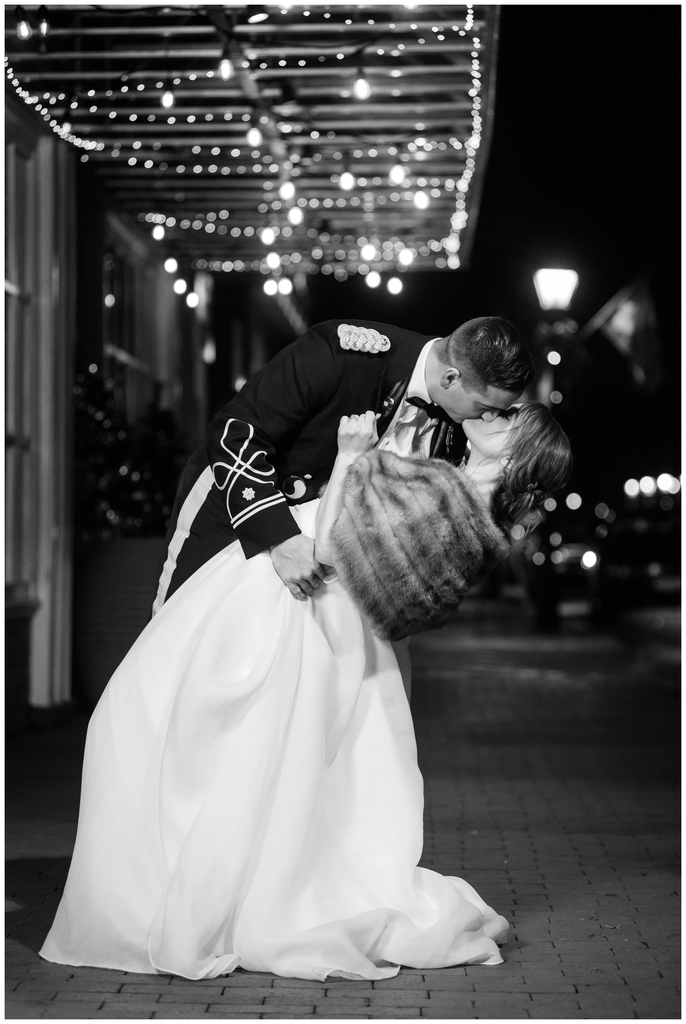 bride and groom kiss under street lights in fredericksburg virginia