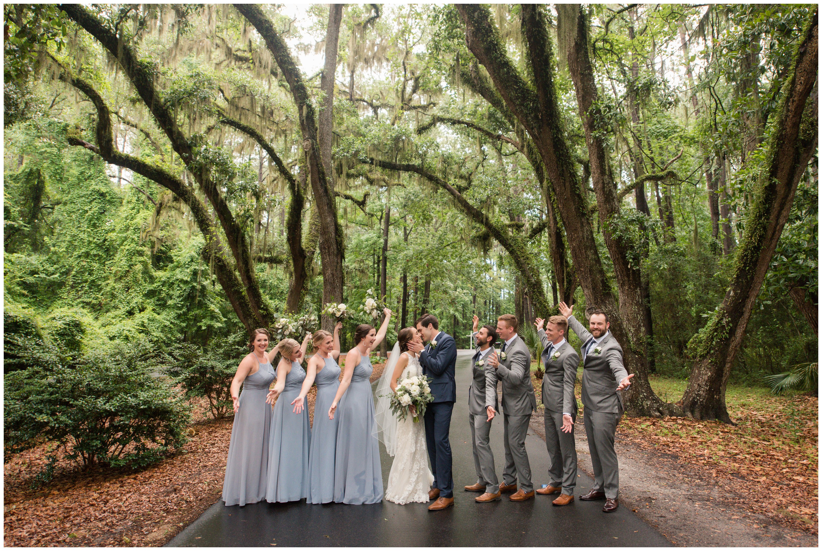 wedding party stands under spanish moss trees at south carolina wedding