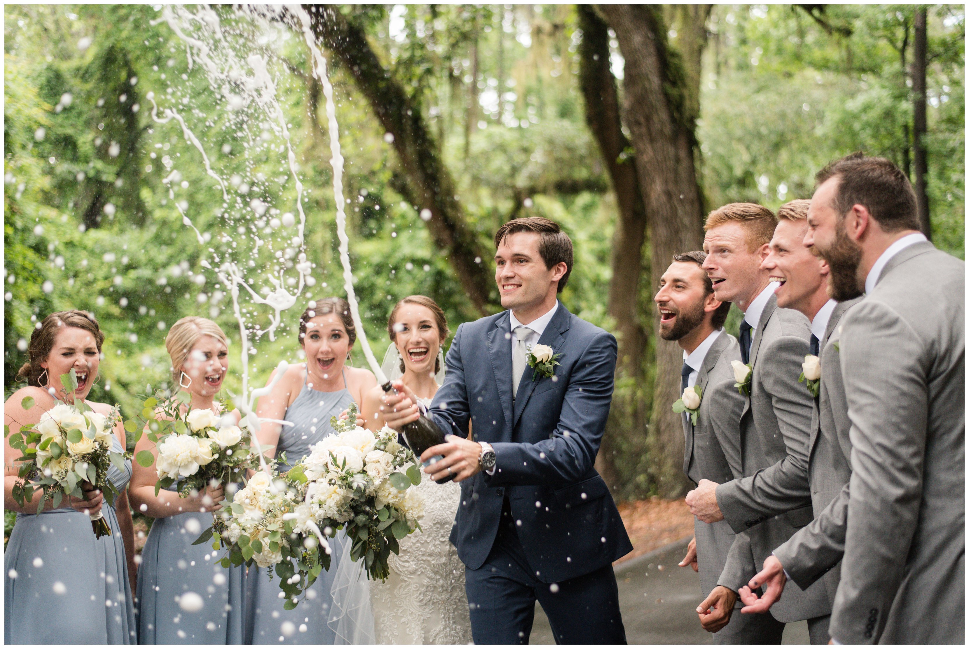groom pops champagne with wedding party at south carolina wedding 