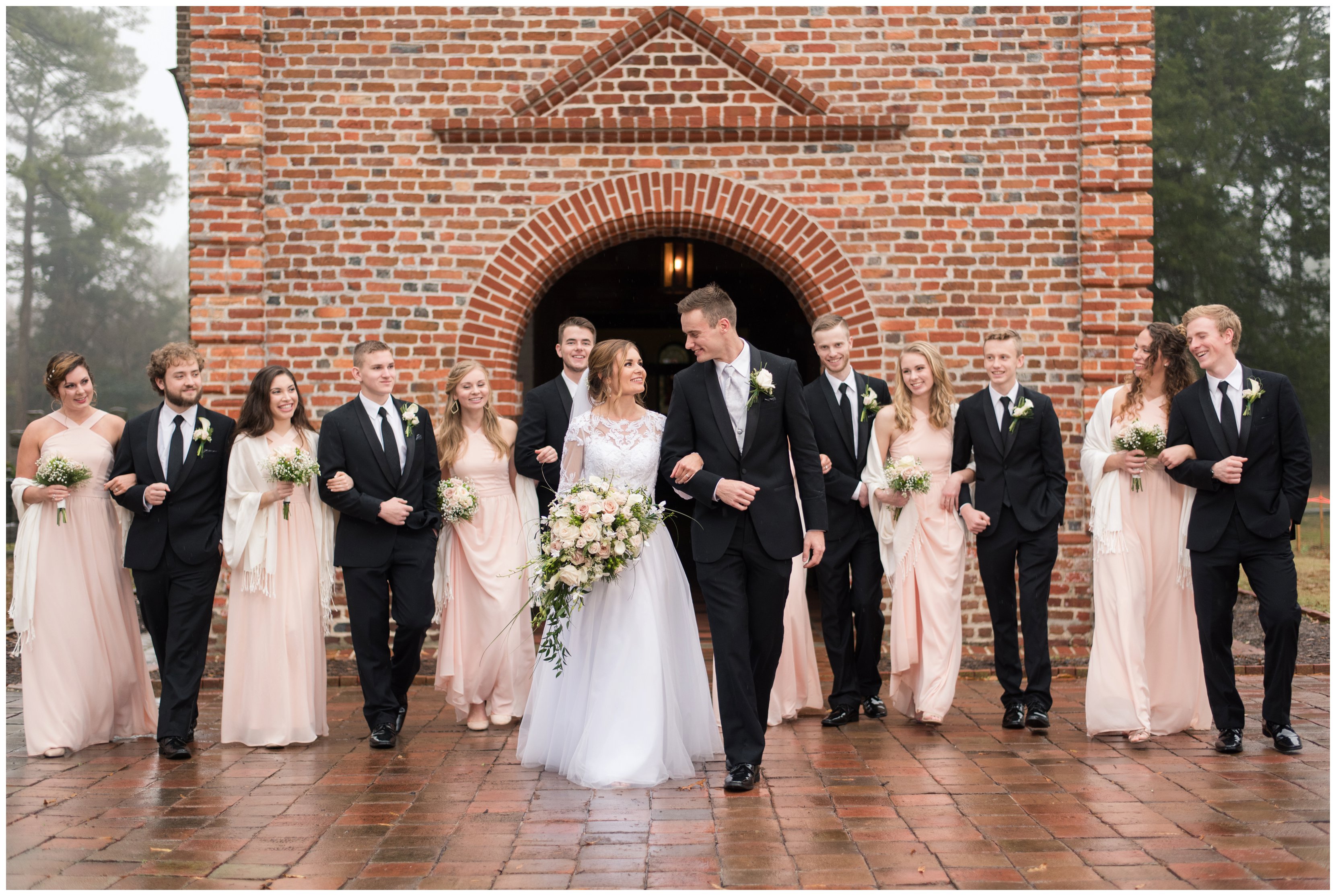 bridal party walks together outside of historic st lukes church wedding