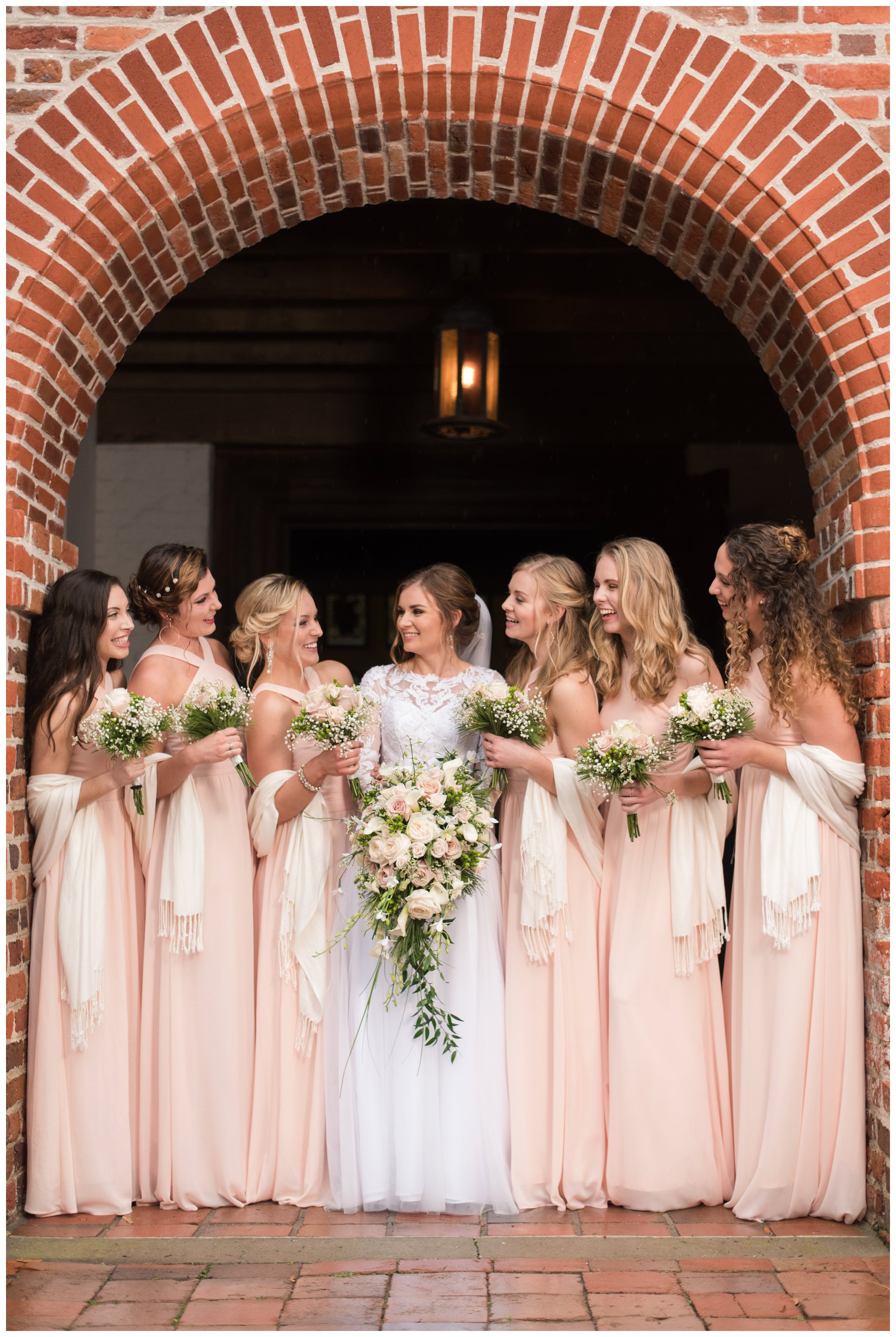 bridesmaids smile together at historic st lukes church wedding