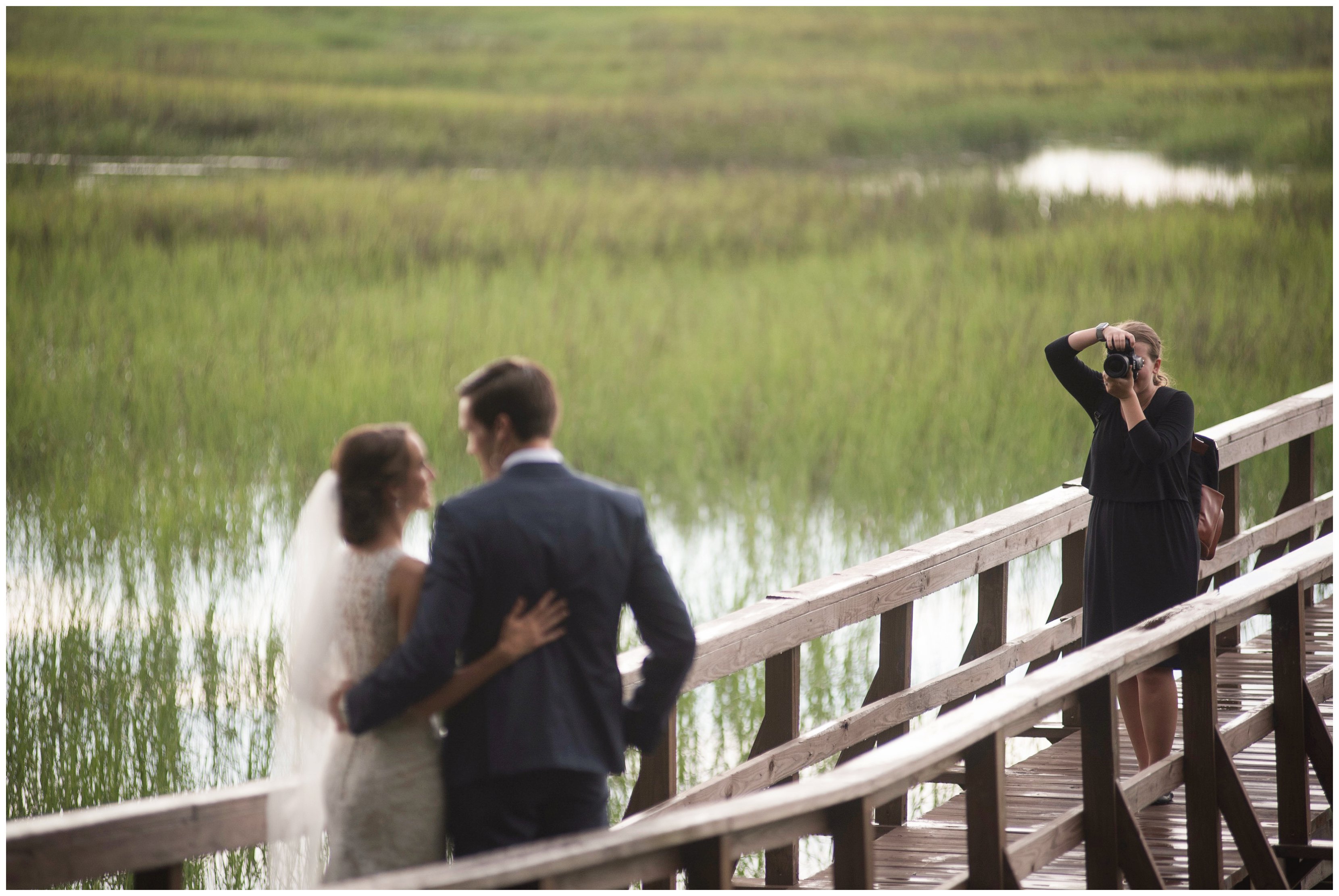 couple stands together while virignia photographer photographs them at wedding