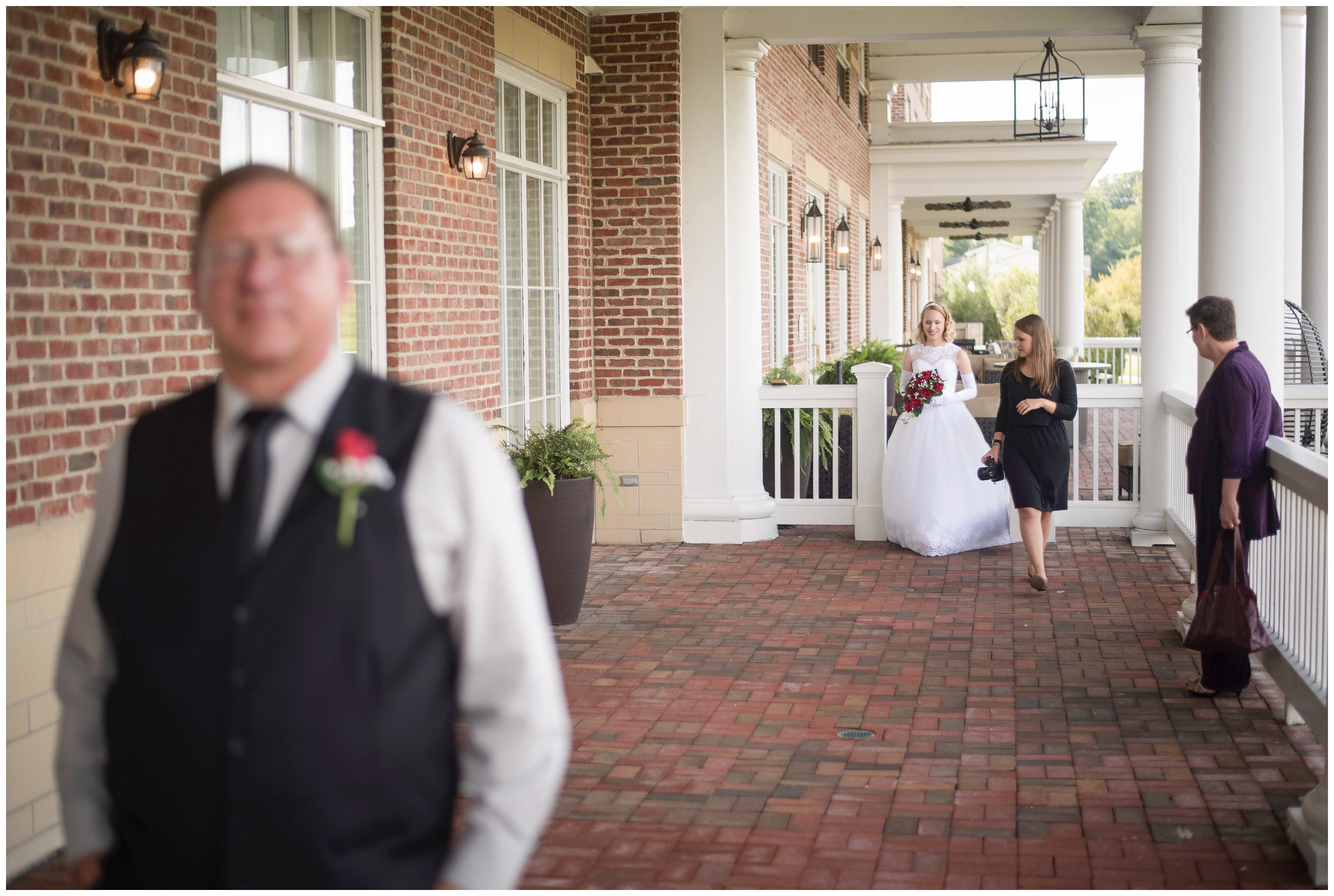 va photographer walking bride to first look with father