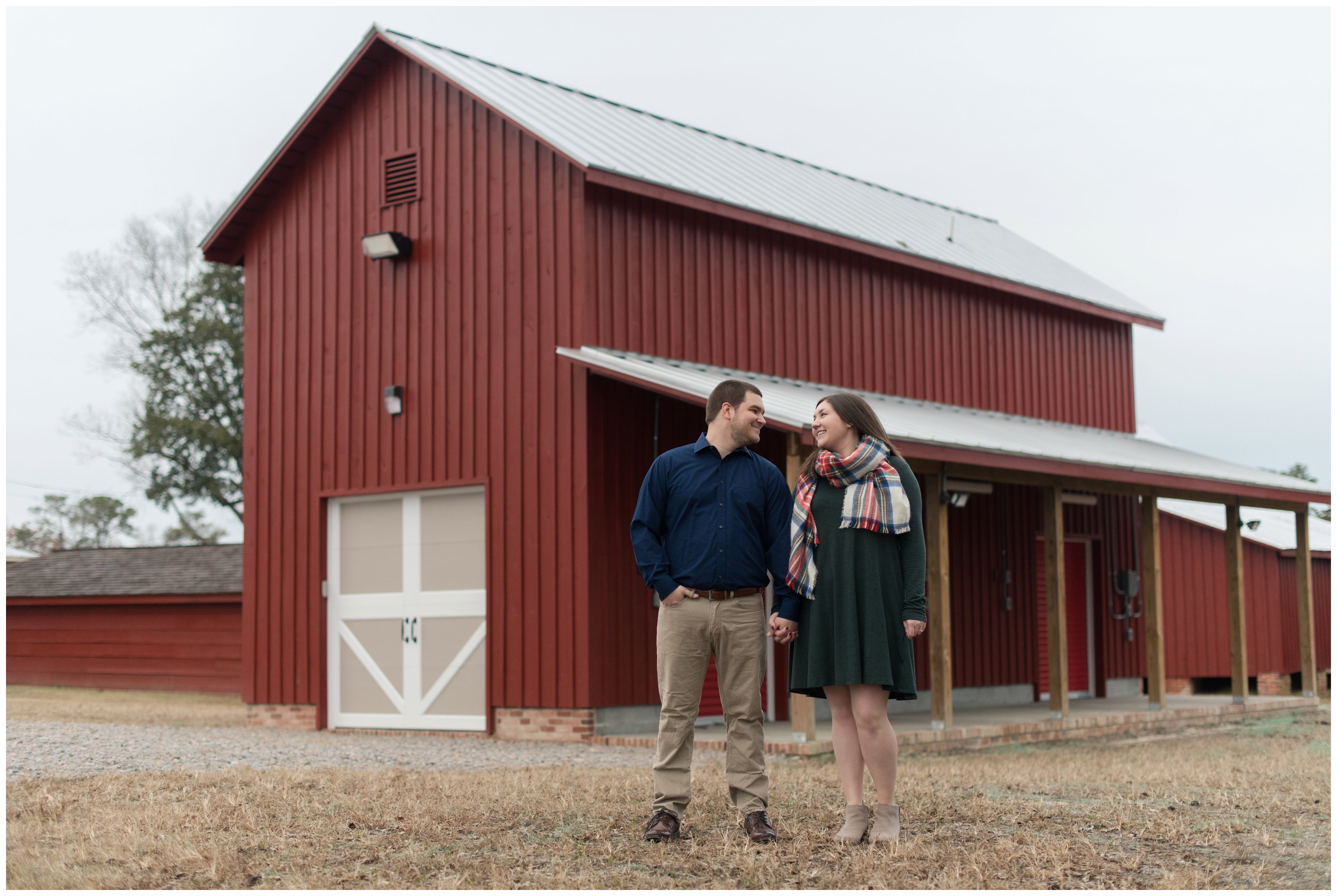 couple in front of barn at smithfield engagement session by virginia wedding photographer